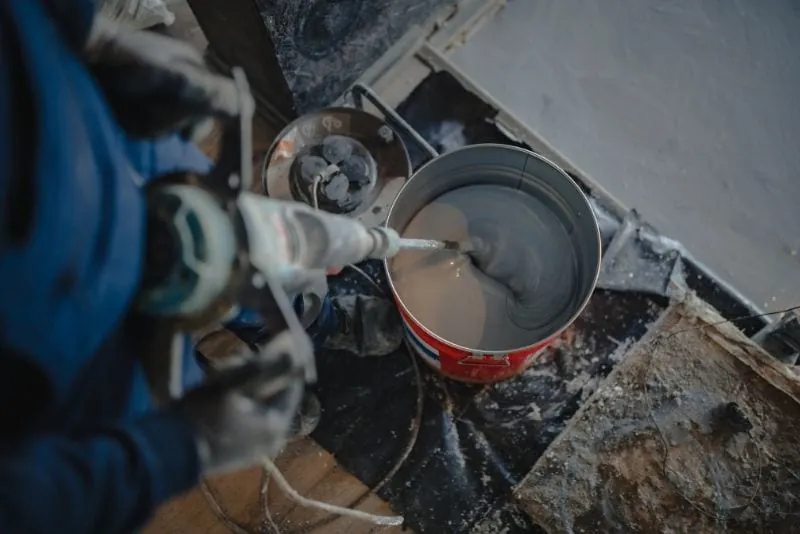 Close-up of amber epoxy resin being mixed before application