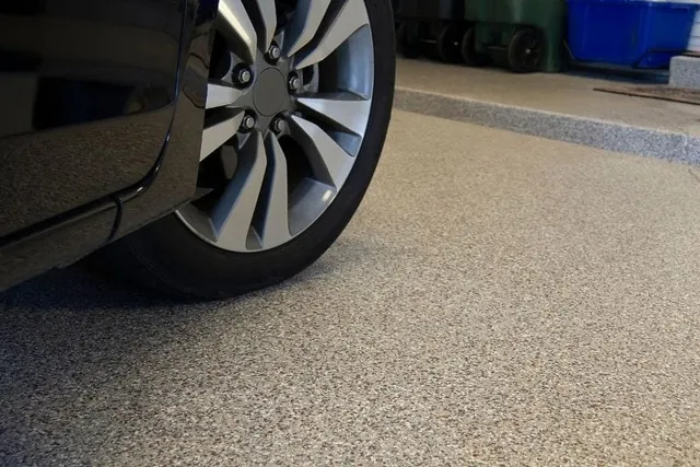 Car parked on a speckled flake epoxy garage floor coating