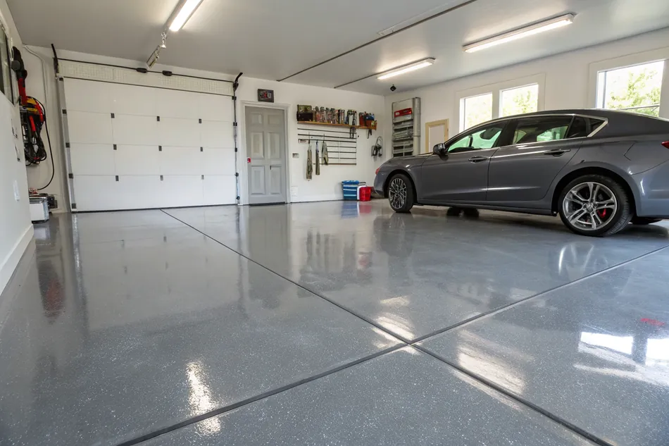 Clean residential garage with a glossy solid grey epoxy floor