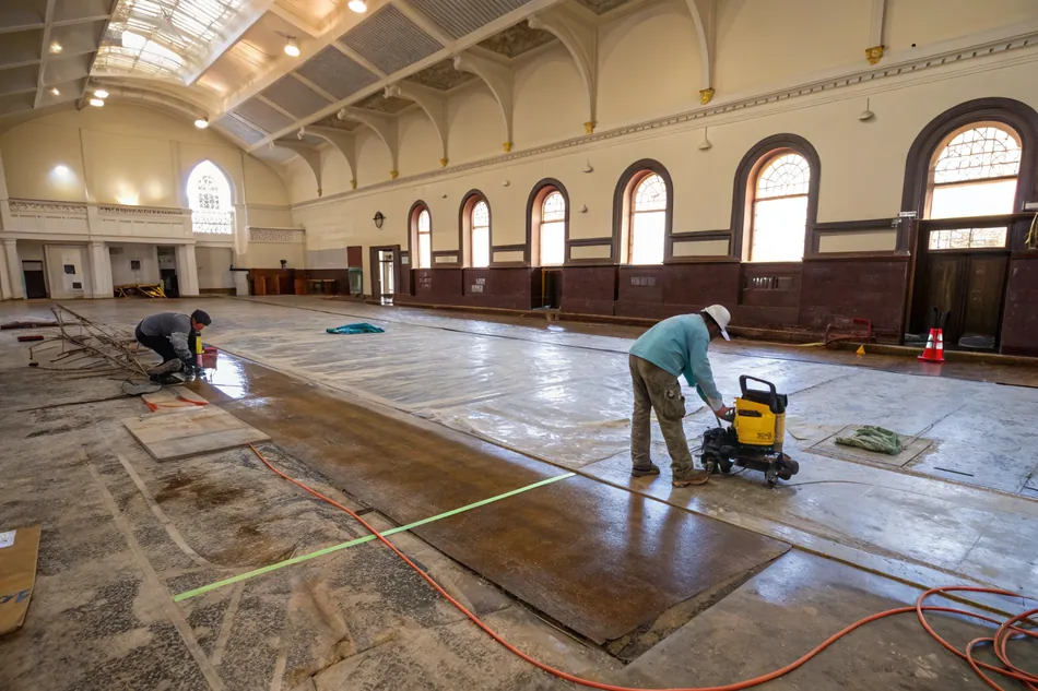 Historic Wollongong building interior showing an aged, worn concrete floor before conversion
