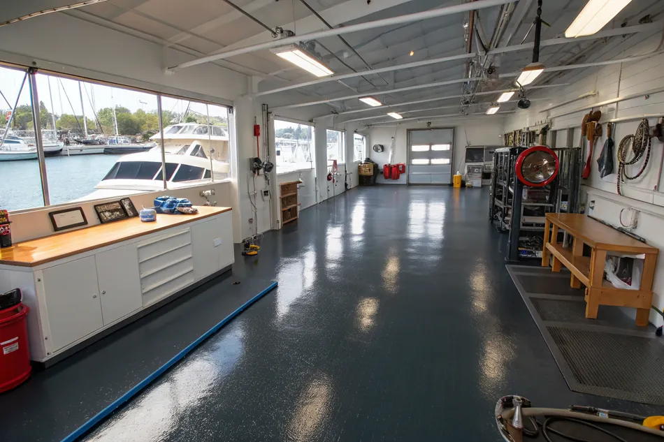 Marine workshop interior with a dark charcoal epoxy floor
