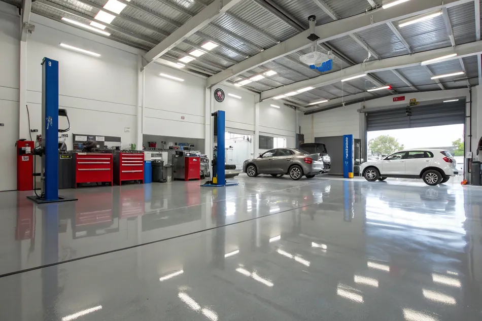 Automotive workshop interior in Wollongong with clean epoxy flooring around service bays