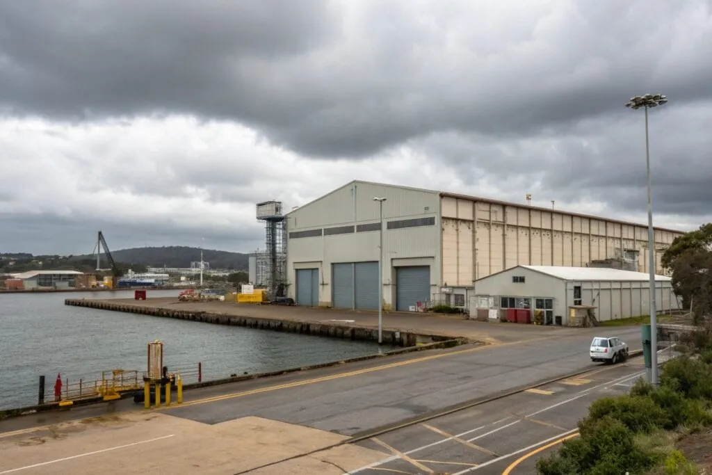 Exterior of a large industrial warehouse facility near the waterfront