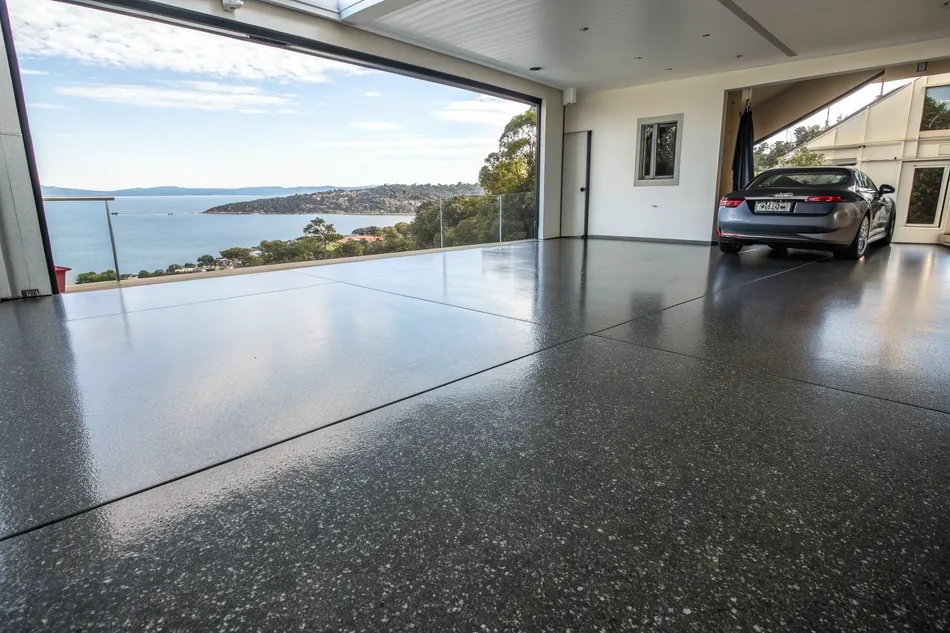 Wide angle view of a pristine marine-grade epoxy garage floor overlooking the coast