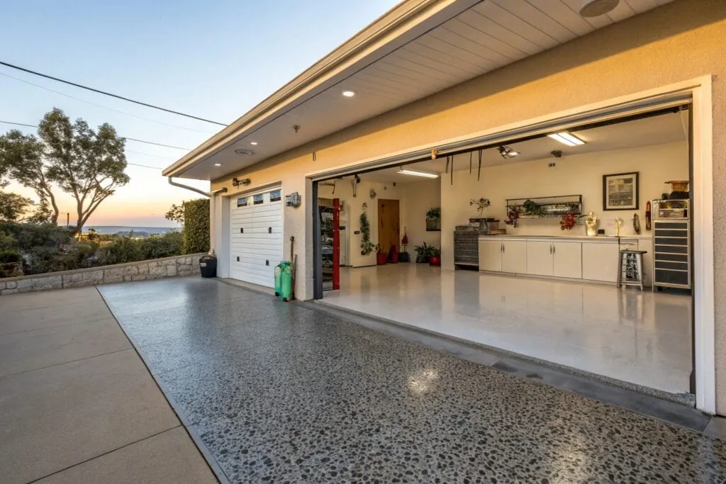 Well-maintained epoxy garage floor with decorative flake finish in a coastal home