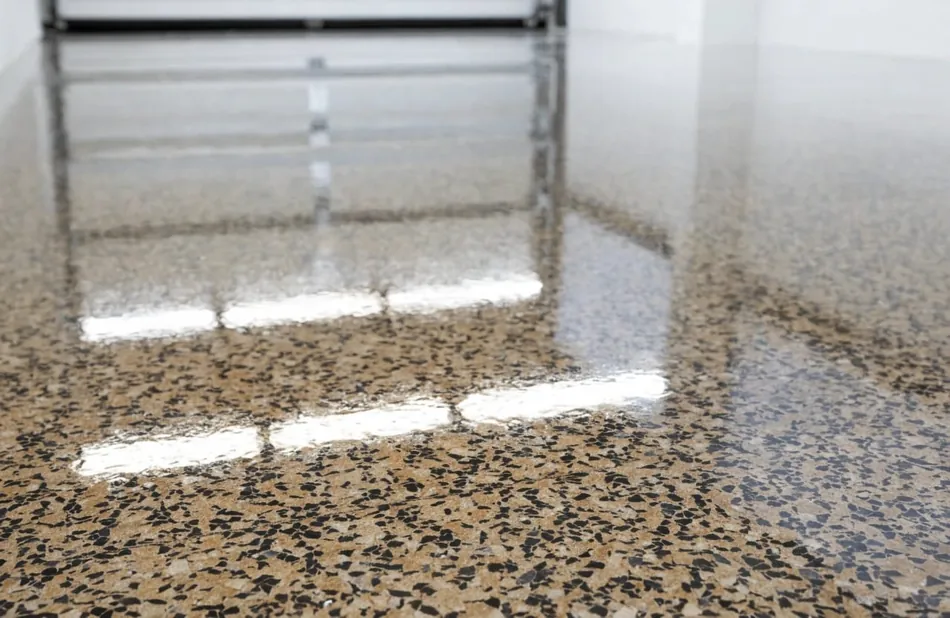 Close-up of polyaspartic epoxy floor finish with vinyl flake broadcast in a garage