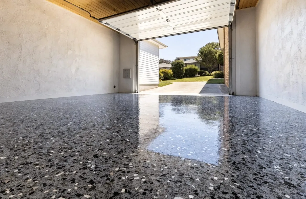 Epoxy garage floor coating with charcoal flake finish in a residential property